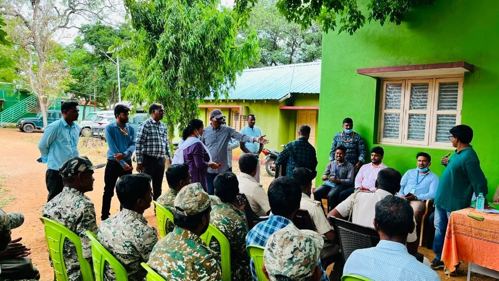 Preventive healthcare awareness and occupational safety briefing under forest canopy.