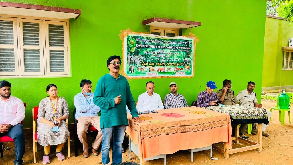 Dignitaries, medical officers, and forest department leadership presiding over the health camp inauguration.
